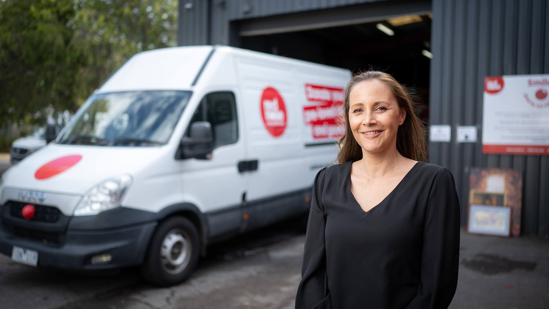An employer outside her business in a black top